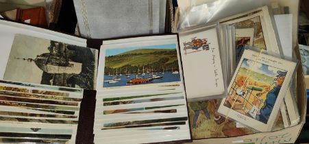 A selection of vintage postcards in albums and loose and a quantity of ephemera