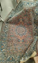A hand knotted Isfahan style rug with red ground  with blue highlights, width 147cm