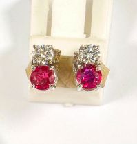 A pair of 18ct white gold diamond and ruby set earrings. Diamond 4mm diameter. Ruby 4.5mm
