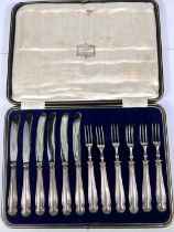 A cased set of 6 silver handled knives and forks, filled centres, Harrods case