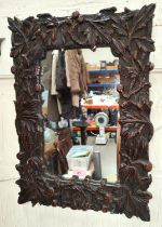 A late Victorian mirror with carved oak frame, 52 x 38cm, overall