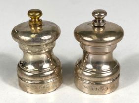 A hallmarked silver pair of pepper grinders, London, date marks worn