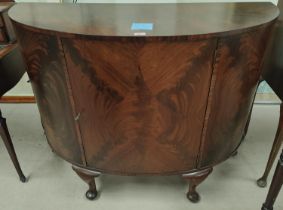 A mahogany quarter veneered bow fronted side cabinet with interior shelf Length 122cm