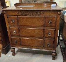 An oak 1930's chest of three drawers with bulbous legs and panel fronted decoration, height 100cm,