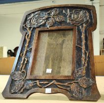 A Wooden arts and crafts picture frame with rose and thorn decoration, height 42cm