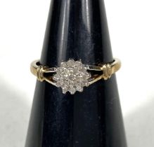 A 9ct gold ring with diamond flower head, 19 stones, 1.8gm