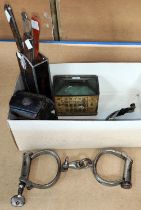 A pair of handcuffs; a pair of spurs; an old bicycle lamp; etc.