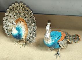Two silvered metal peacocks with enamelled decoration