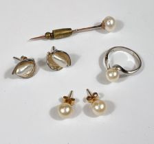 An 18 carat white gold pearl ring 3.10gm, a pearl stick pin and two sets of Pearl earrings