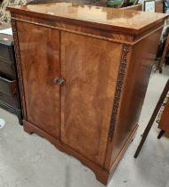 A mahogany reproduction two door cupboard with figured doors, 76 x 52 x 94cm by Richardson of London
