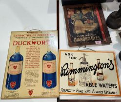 A vintage Diamond Dyes advertising poster mounted on wooden back a cardboard Remington's table