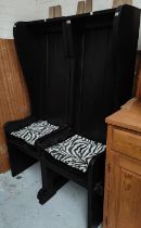 A pair of unusual high back chairs in black finish