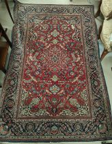 A hand knotted Isfahan style rug with blue ground red highlights width 133cm