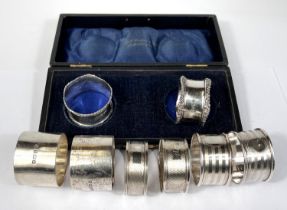A cased pair of hallmarked silver napkin rings, 1918 and 3 other pairs of hms napkin rings, gross
