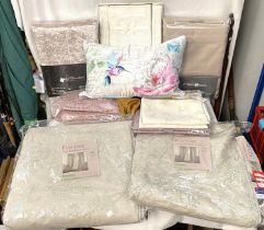 A selection of linen, unopened curtains etc