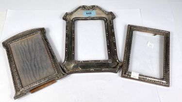 An ornate rectangular hallmarked silver photo frame with reeded rims and bow pediment, ht. 23cm