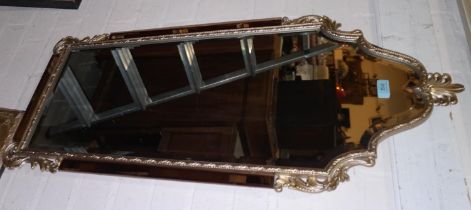 A period style rectangular, bevelled edge wall mirror with arched top, in a gilt frame with peach
