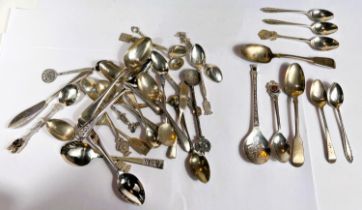 A selection of white metal spoons inc. some souvenir spoons stamped 'Sterling'; a selection of