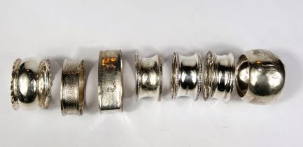 Six hallmarked silver napkin rings, various Assay offices and dates, a napkin ring stamped Sterling,