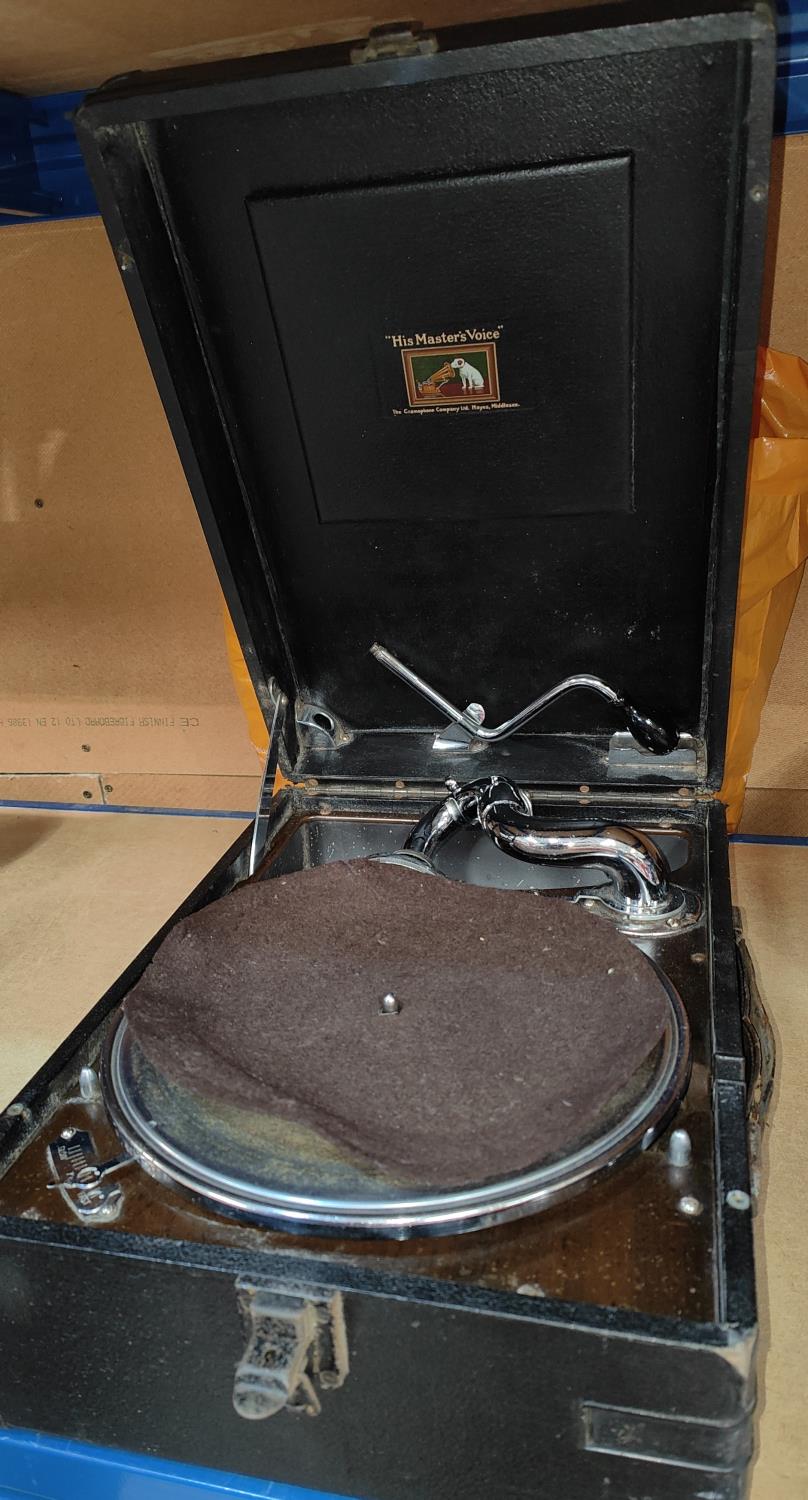 An HMV portable wind up gramophone and 78 rpm records