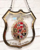 BY APPOINTMENT TO H.M THE KING OF SPAIN, an enamelled and gilt glass armorial pendant shop sign,