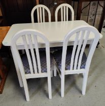 A white kitchen table and four white hoop back chairs