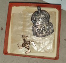 A 9ct gold Scout medal, 2.5gm and a silver ARP button hole badge