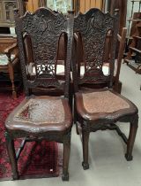 A pair of 19th century Chinese/Japanese highly carved chairs with peacock back' pierced
