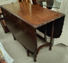 A 1930's occasional table with scalloped rounded rectangular drop leaf top, on barley twist legs