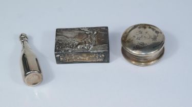 A hallmarked silver vesta box holder with embossed stag; a circular silver patch box; a novelty