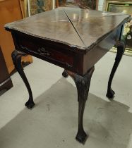 A mahogany card table with quatrefoil folding top, on cabriole legs and ball and claw feet