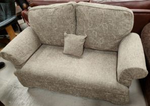 A traditional style 2 seater settee in brown leaf rot fabric.