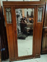 An Edwardian small wardrobe with mirror door and glazed panels