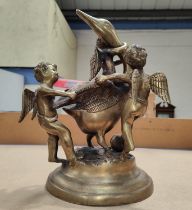 A brass group of swan and cherubs