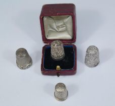A hallmarked silver thimble, one cased; 2 white metal thimbles