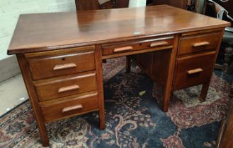 A 1930's oak kneehole office desk with pullout slides and 6 drawers