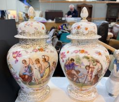 A pair of lidded baluster vases with polychrome decoration of classically dressed figures with