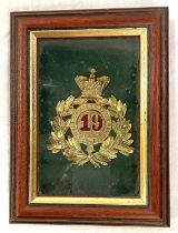 A military Shako badge 19 Green Howards, framed