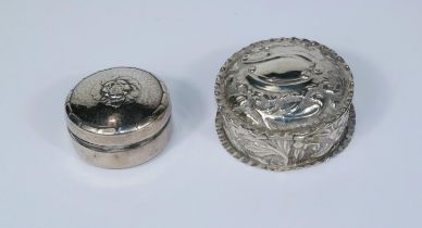 A hallmarked silver circular pill box, embossed decoration, Birmingham 1894; a floral embossed patch