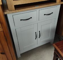 A light grey side cabinet with two drawers and a double cupboard with a light oak top.