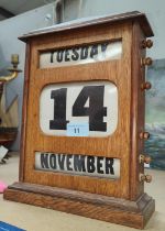 A 1930's oak perpetual calendar