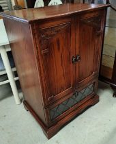 A reproduction carved oak TV cabinet in the Titchmarsh & Goodwin manner