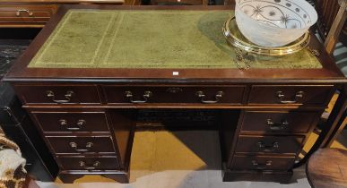 A reproduction mahogany kneehole desk with inset leather top and 9 drawers