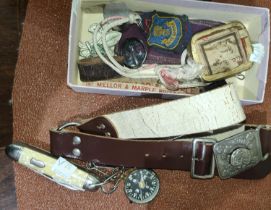 A collection of Scouting and Girl Guide items including badges, belts, compass, pocket knife etc