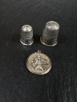 Two 19th century Chester hallmarked silver thimbles and a St Christopher medal