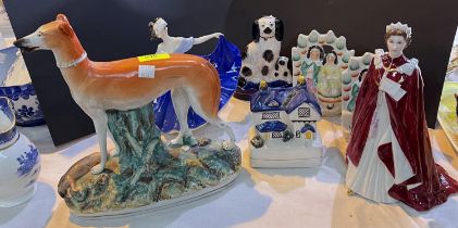 A 19th century Staffordshire greyhound with game; 4 Staffordshire female figures; a Royal