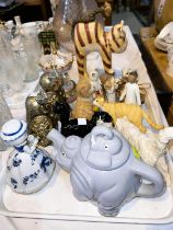 A black and a white Royal Doulton cat; an elephant teapot; other animal figures