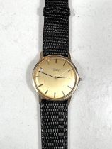 UNIVERSAL GENEVE: a c.1960 gold Swiss watch with gold dial, black hands and black/gold batons,