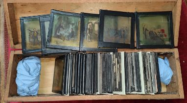 A selection of vintage glass lantern slides in wooden box