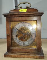 A Georgia style bracket clock in oak case with brass dial and chiming movement